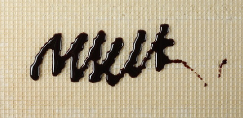 Melted chocolate, cream topping on wafer, waffle surface background and texture