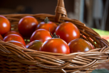 red ripe tomatoes in nice knitted basket