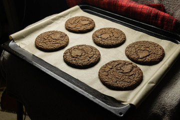 Baked, fresh, delicious chocolate chip cookies on a blackboard. View from above