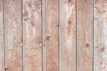The texture of the old painted wall is covered with cracks and roughness close-up.