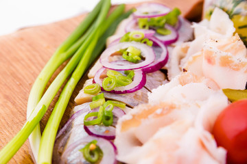 Russian traditional snack on a wooden board on a white background