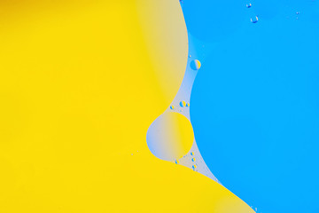 colorful drops of oil waves on water surface, liquid tension, abstract background