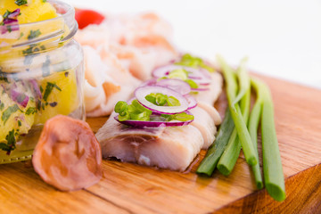Russian traditional snack on a wooden board on a white background