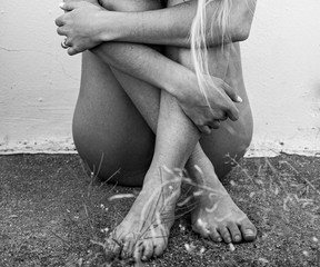 naked woman in the sand, black and white body. 