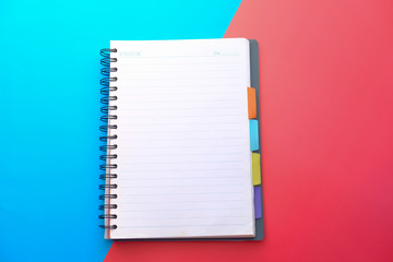 empty notepad on color background , Top view 