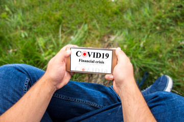 Man holding phone and checking economy during the corona crisis