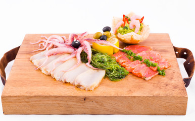 Fish platter on a wooden board on a white background