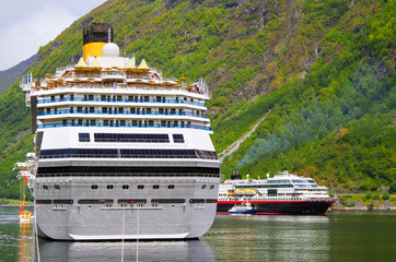 Huge Italian Costa Cruises cruiseship or cruise ship liner Costa Favolosa and Hurtigruten MS...