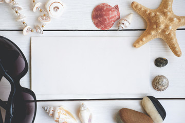summer sale flat lay. top view of sunglasses, shells and sea style necklace. vacation and holiday concept. sea star and stones with place for advertising