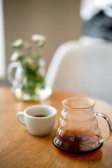 Black filter coffee on the table in cafe service kettle hario pour over cup