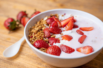 Breakfast with yogurt, granola, with superfood toppings, closeup view. Concept of healthy eating, healthy lifestyle
