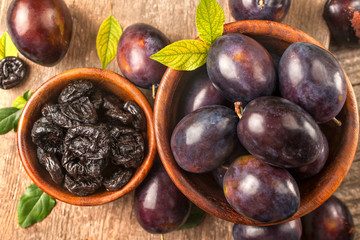 Healthy organically grown plums with dried plum fruits on a wooden rustic table