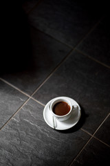 cup of black filter coffee on the floor daylight sunlight morning coffeebreak spoon