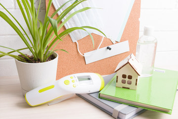 table for working from home, studying at home, infrared thermometer and means of protection against...