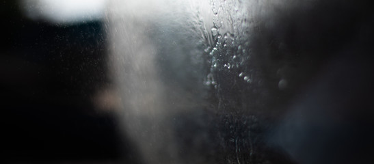 Small drops of water beaten by the sun in the counter-jour form gray abstractions