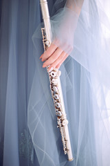 woman in blue dress holds flute