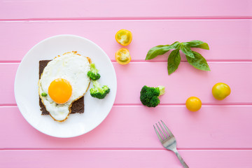 Toast with fried eggs and vegetables for lunch or brunch.