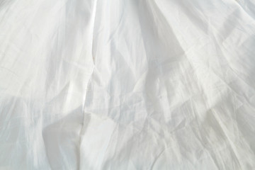 Crumpled parchment texture of white baking paper