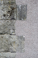 Close up of Rough Stone Blocks on Corner of Wall of Grey Textured Cement 1640-1001-003