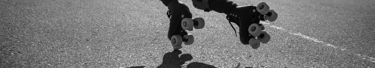 two roller skates just before falling on the astalt surface