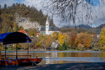 Traditional Pletna boat on the Bled lake with swans. In the background is the famous old castle on the cliff. Bled lake Slovenia