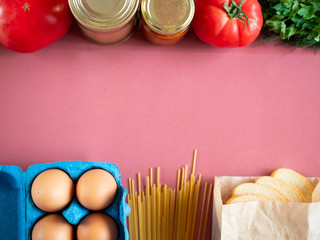 Food supplies on pink background, top view with copy space