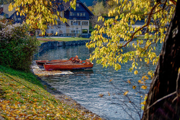 Scenic view on beautiful wooden traditional Pletna boats on the Bled Lake , Slovenia. A boat that transports tourists to the island where the church Assumption of Maria is located.