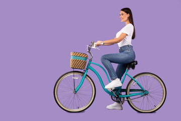 Beautiful woman riding her bike at studio, isolated