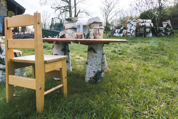 children's table with chair, table legs from birch trunk, sawn birch firewood