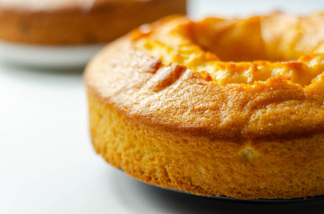 Freshly made madeira ring loaf cake decorated on white background