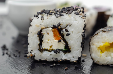 Close up of soft cheese, red pepper and chive California roll, traditional Japanese food
