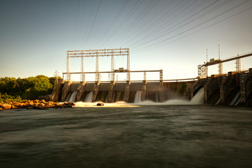 A long-exposure of a large dam and the spillway.