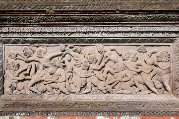 Violent stone wall carving Pura Dalem Penunggekan Temple Bali Indonesia