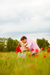 Fototapeta premium child with dad picking flowers in poppy field