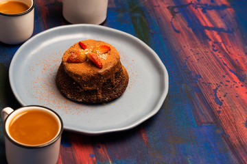 Chocolate cake whit sweet breadlue table.