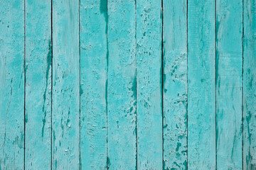 Fototapeta na wymiar Cracked blue wood background. Timber vertical plank, scratched surface. Turquoise wooden fence background. Copy space. Vintage texture boards.
