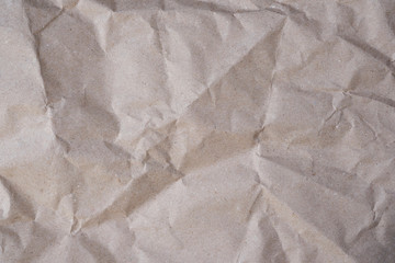 Gray wrapping paper crumpled background. Paper for packaging parcels top view. Texture of crumpled sheet of paper. Craft wrinkled crumpled.