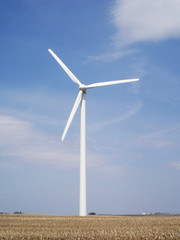 Windmill, single, creating energy on a farm in Iowa, USA