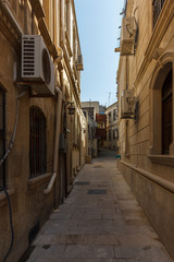Fototapeta na wymiar Azerbaijan, Baku, Icheri Sheher streets of the old city, color and ordinary life of citizens. Balconies, alleys, terraces, narrow walkways