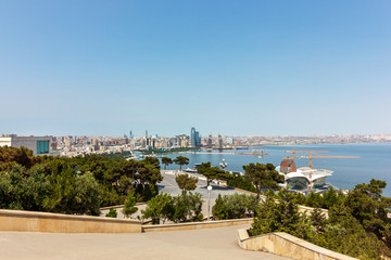 Fototapeta na wymiar Azerbaijan, Baku, panorama of the city. Tourist places for walking along the shore of the Caspian Sea. The architecture of the old and new city. Without people