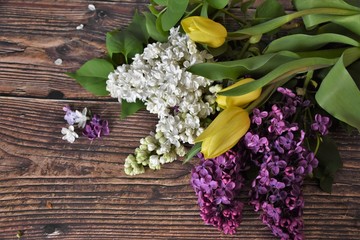 flowers tulips and lilacs on a wooden table