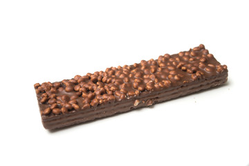 Closeup of chocolate bar with puffed rice on white background