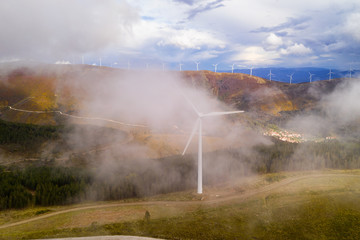 Wind turbines drone aerial view renewable energy on the middle of clouds in Serra da Lousa, Portugal