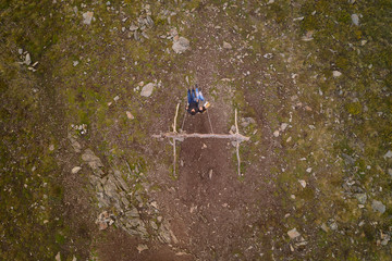 Romantic couple social distancing drone aerial top view swinging on a Swing baloico in Lousa mountain, Portugal at sunset