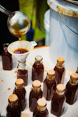 Natural raw honey being processed and bottled.
