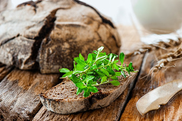 A piece of soft, fresh bread with thyme and other spices. Handmade bread close-up. Bread Story