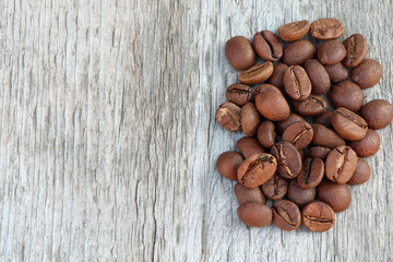Coffee beans on a old wooden background. Roast coffee beans on white wooden table.Coffee grains. Copy space. Space for text. Flat lay.