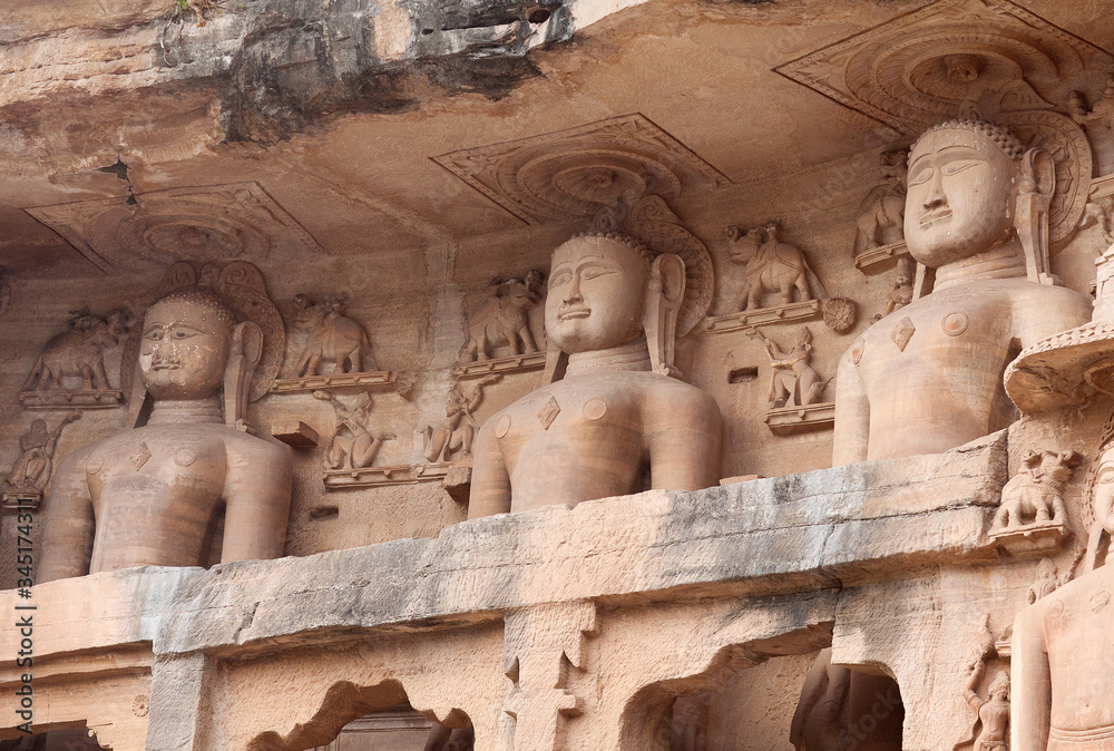 Wall mural ancient jain statues carved out of rock in gwalior, madhya pradesh, india