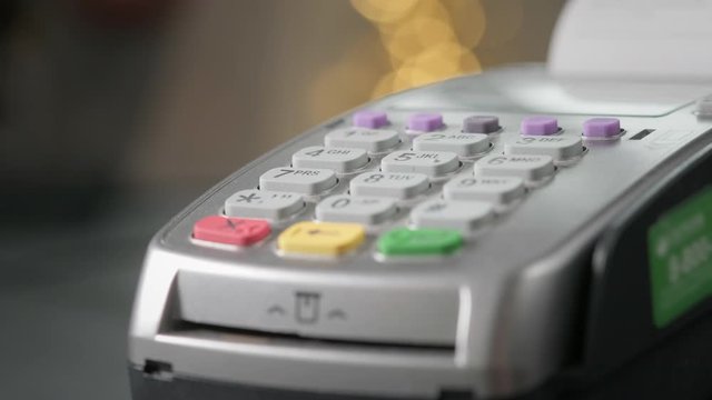 The user makes payment by credit card. Swipe to the terminal of non-cash payment. Man hand with credit card swipe through pos terminal. Banking services of electronic money, making transaction