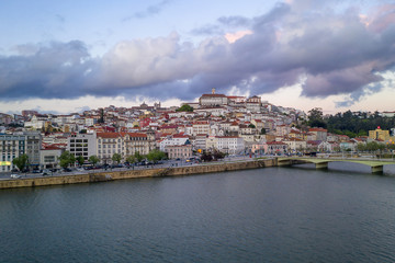 Fototapeta na wymiar Coimbra drone aerial city view at sunset with Mondego river and beautiful historic buildings, in Portugal